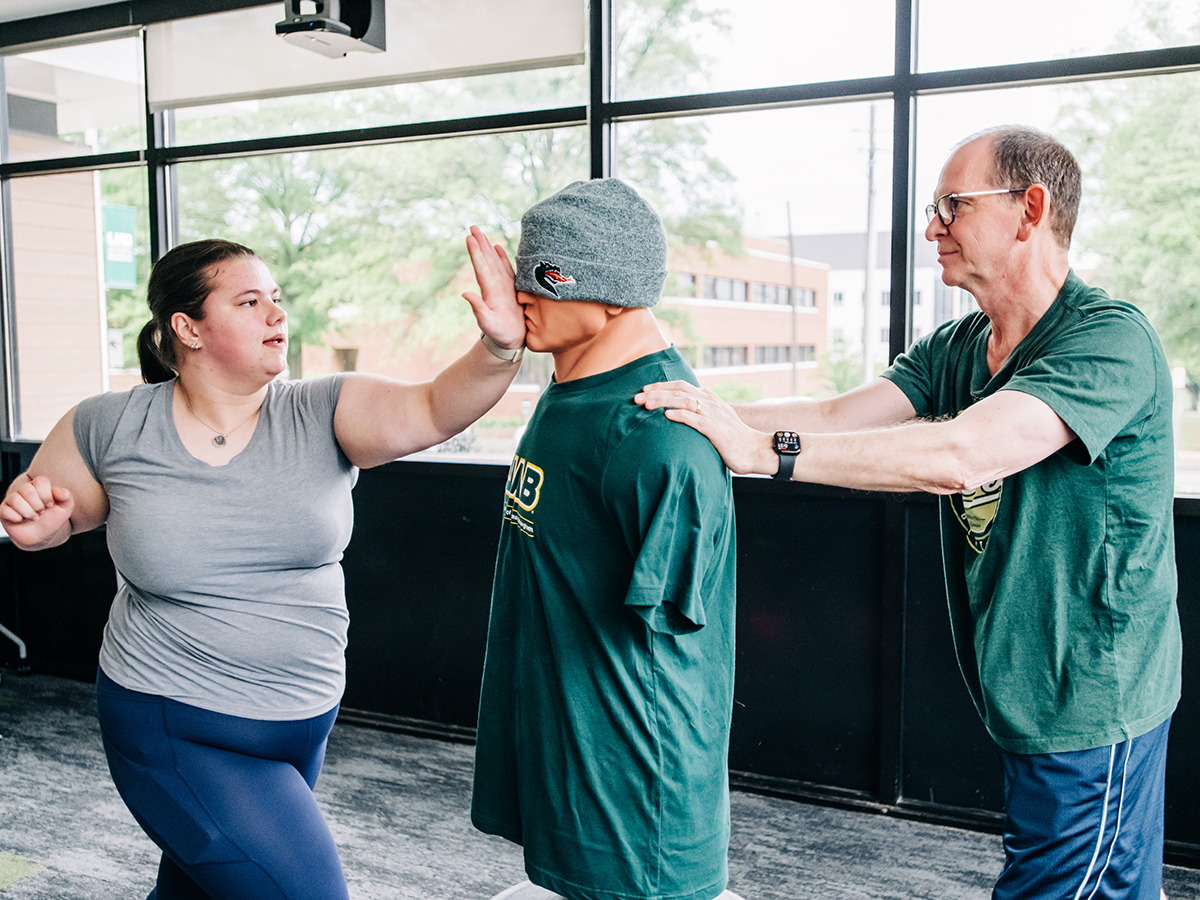 An Honors College student practices tae kwon do with Mark Banaszak Holl, professor in the School of Engineering